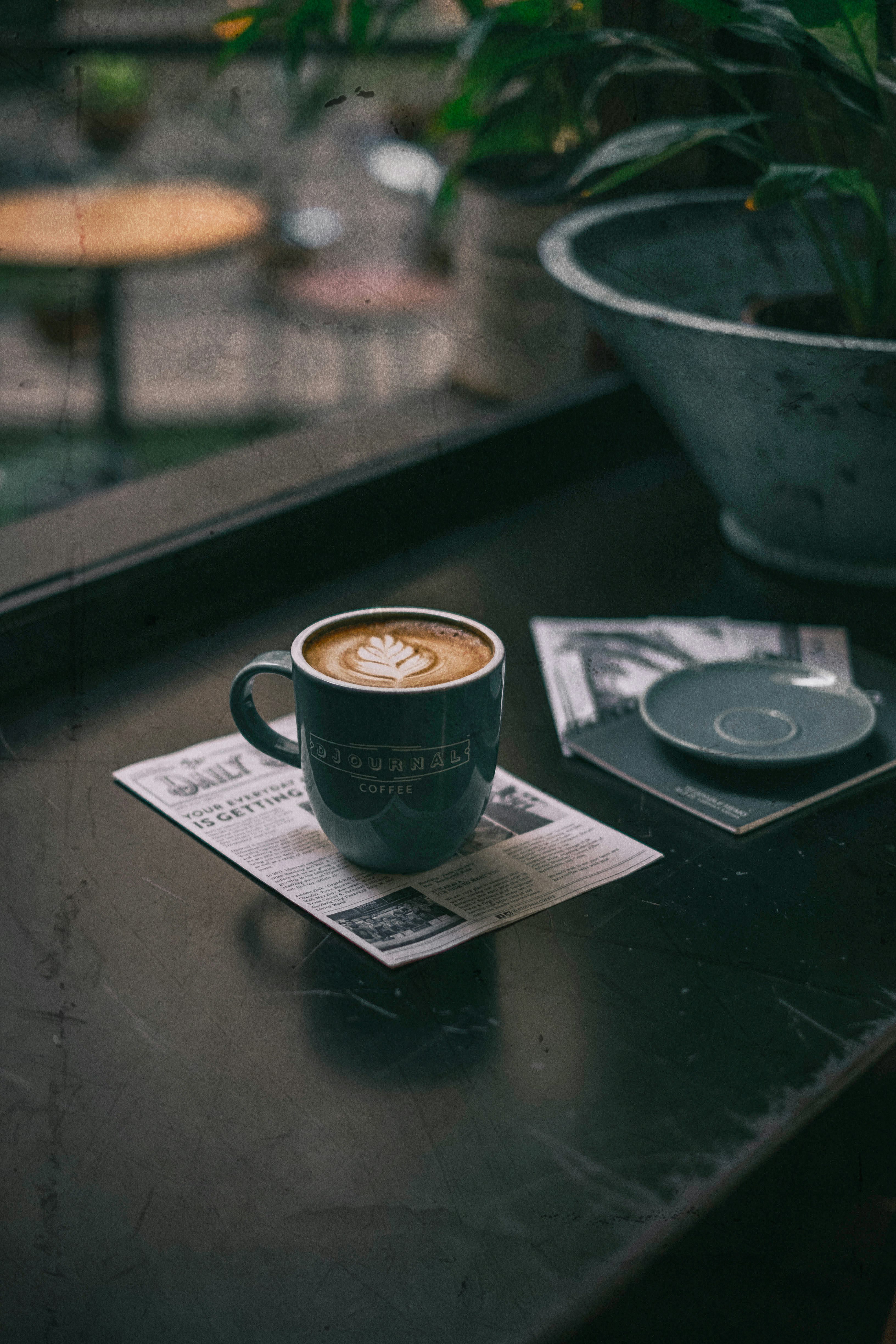 green cup with coffee on table